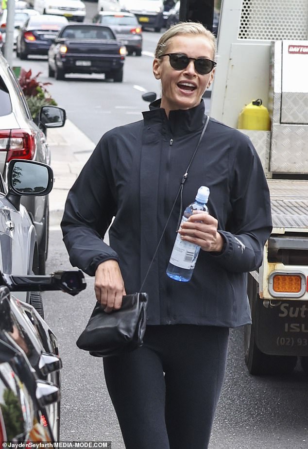 Sarah Murdoch, 50, wears a pair of socks with slides as she steps out