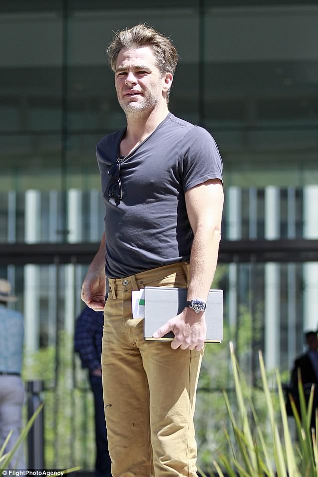 Chris Pine shows off his buff biceps in a tight tshirt as he heads to