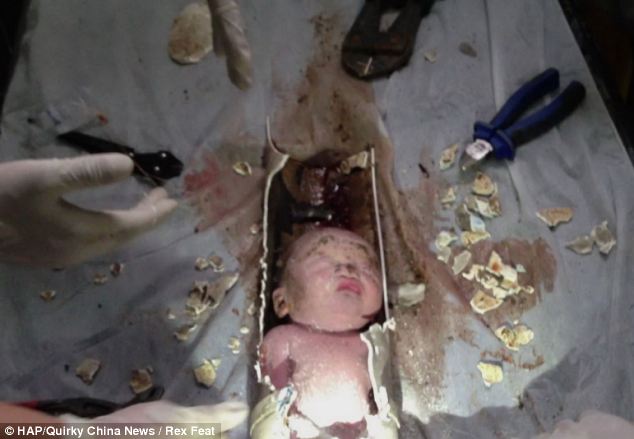 At a public toilet on the fourth floor firefighters were able to hear faint cries and, exploring further, spotted a baby's foot deep inside the pipe