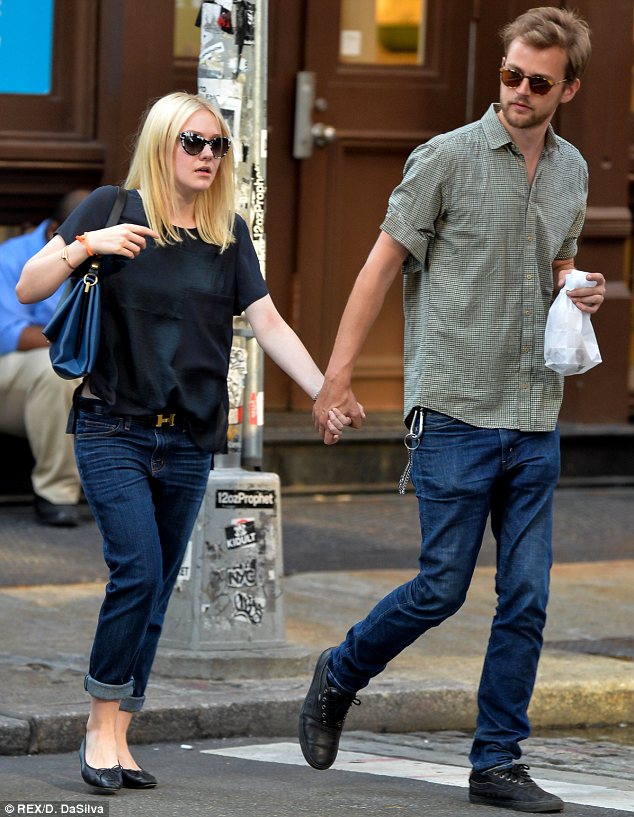 Dakota Fanning keeps a firm grip on her new man as she pulls him out of