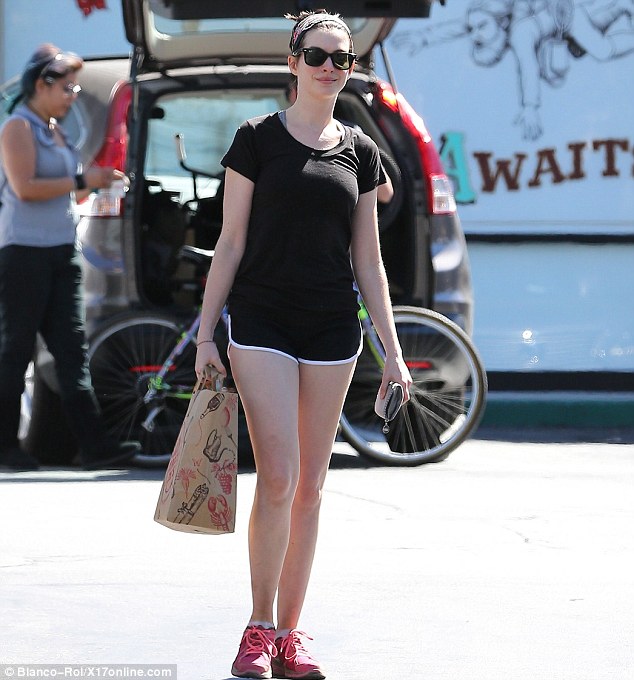 Anne Hathaway shows off a healthier looking figure in gym shorts, year