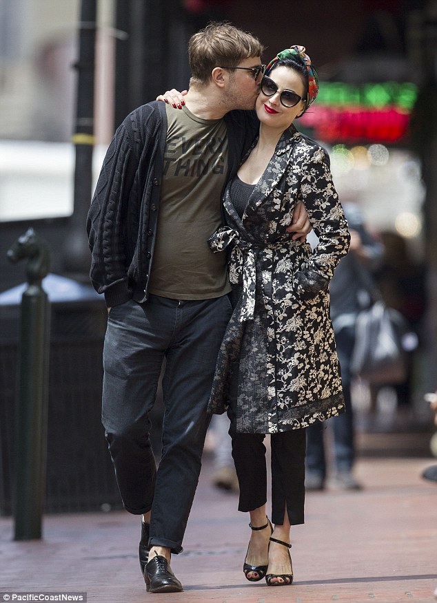 Dita Von Teese receives smooch from scruffy boyfriend as she oozes old Hollywood glamour in