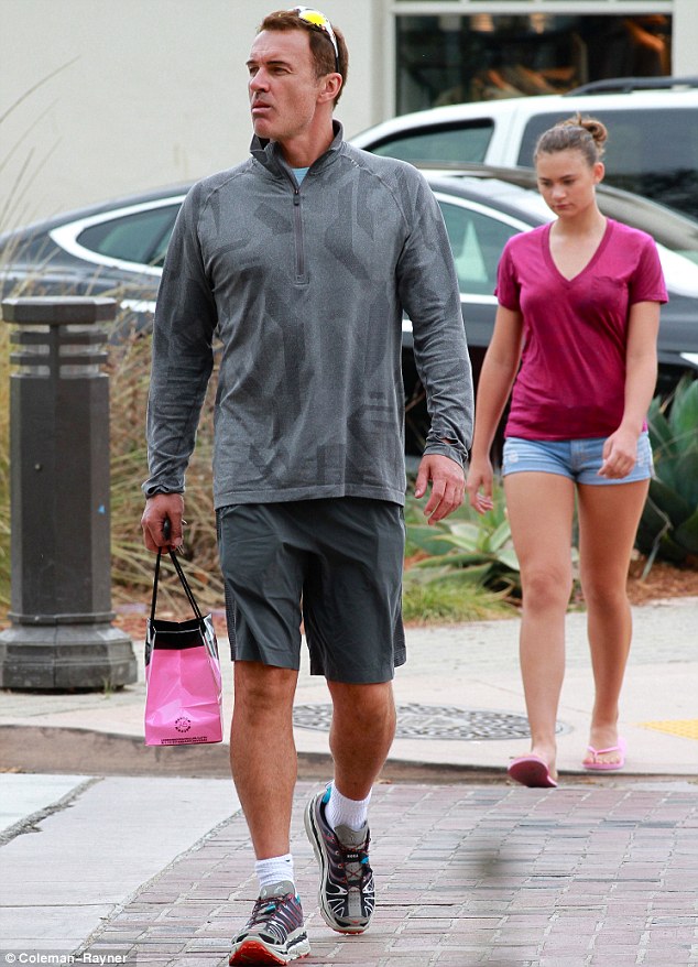 Julian McMahon sports a very bronzed look as he steps out with Kelly