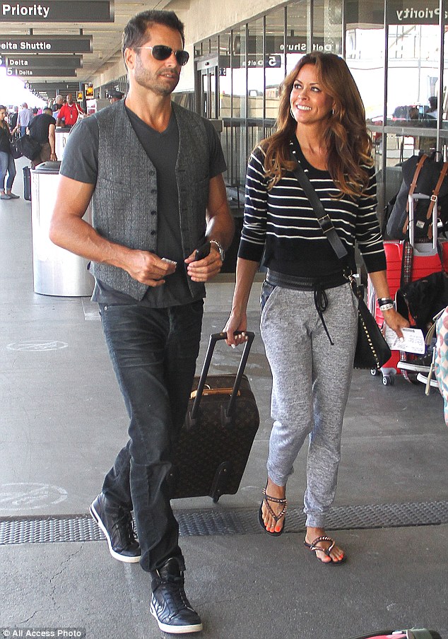 Brooke Burke gives husband David Charvet a loving look as they fly out