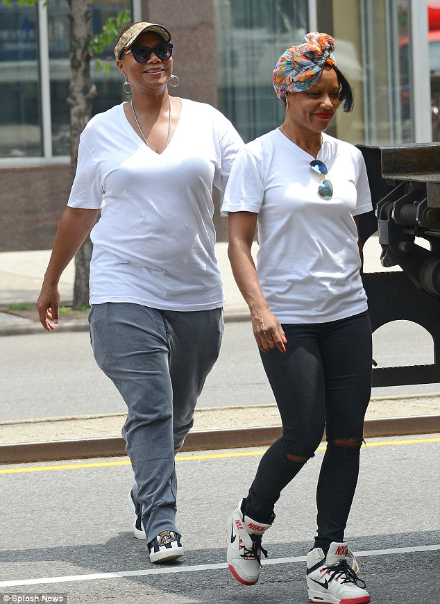 Queen Latifah and partner Eboni Nichols take a leisurely stroll in New