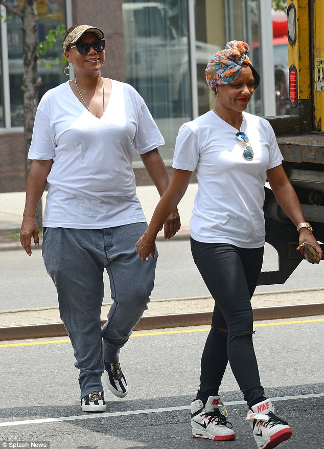 Queen Latifah and partner Eboni Nichols take a leisurely stroll in New