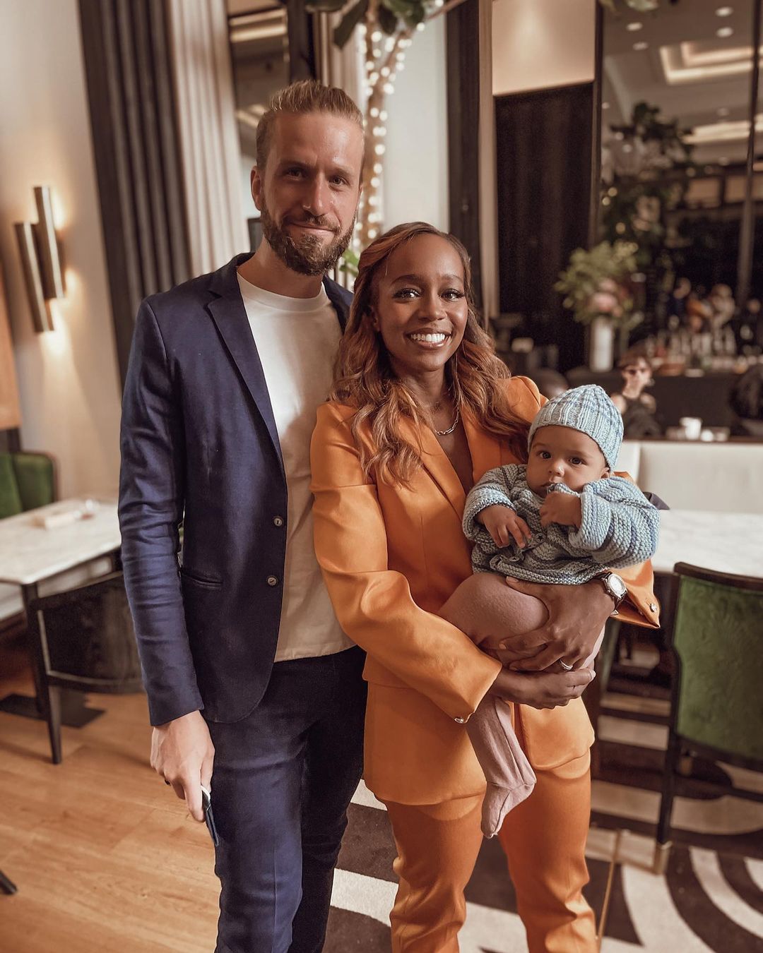 Aja Naomi King and her husband with her newborn son at Paris fashion