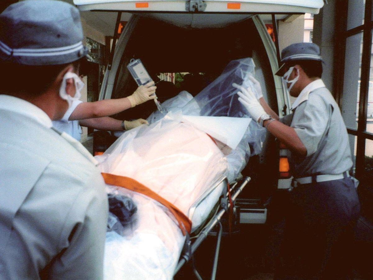 A photo of a plastic wrapped Hisashi Ouchi being transferred after the