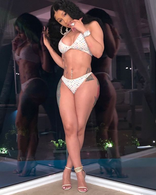 Cardi B shows off the results of her boob job and lipo as she twerks in tiny Gstring bikini