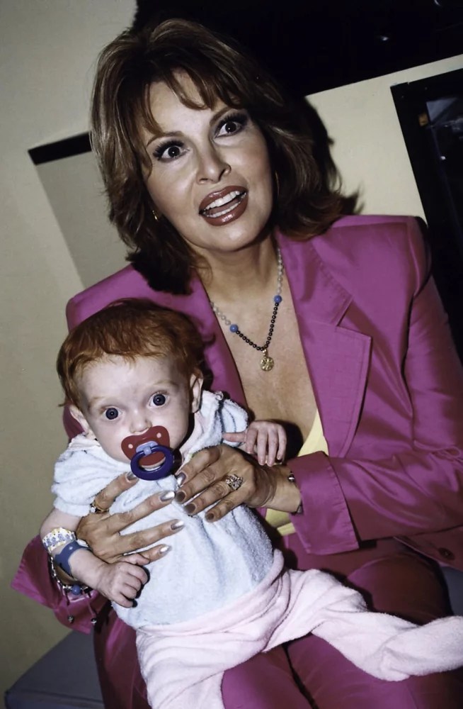 Raquel Welch holding a baby at Westmead Childrens Hospital in Sydney
