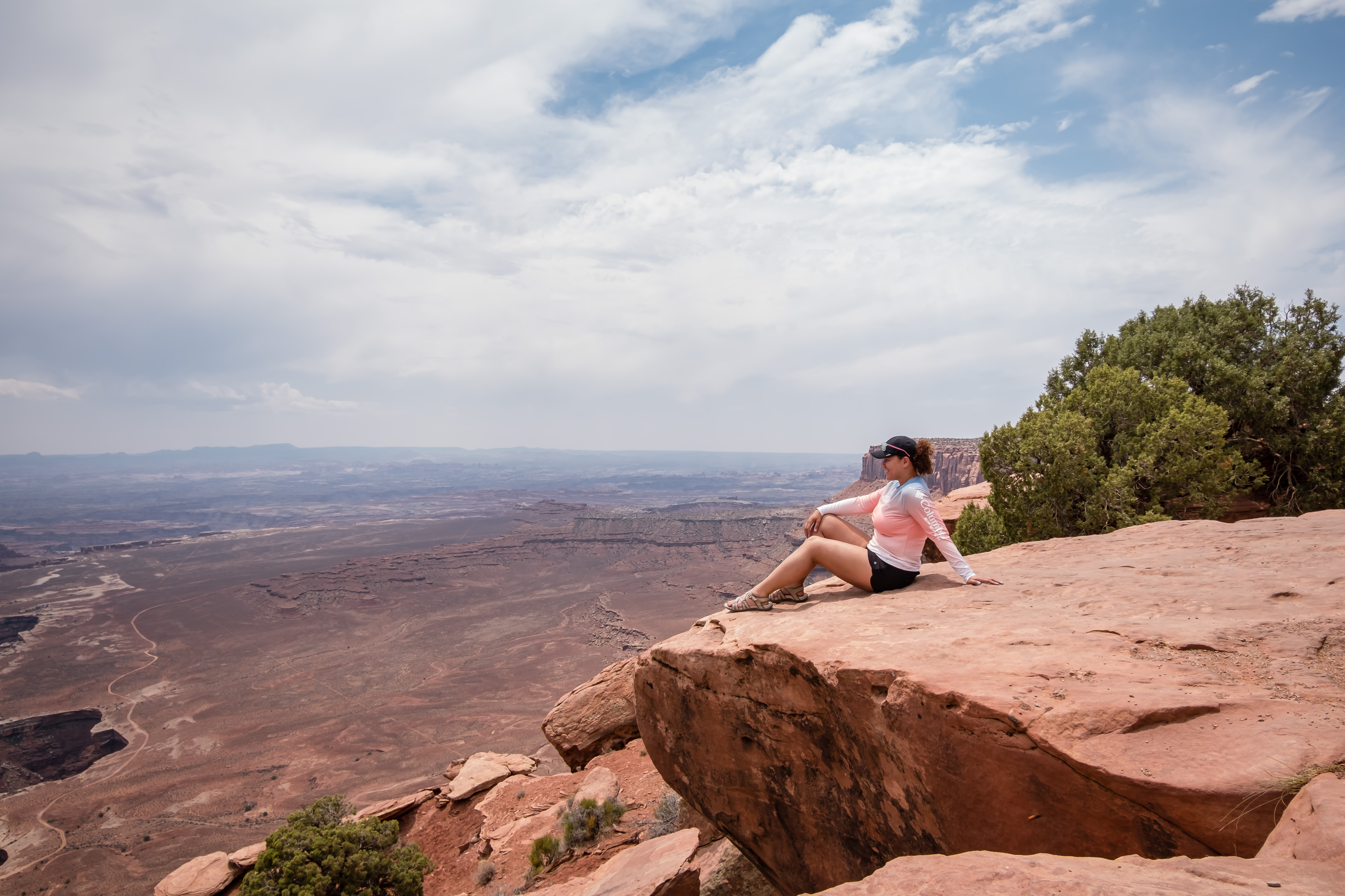 sitting at the canyon edge in the overlooks in island in the sky