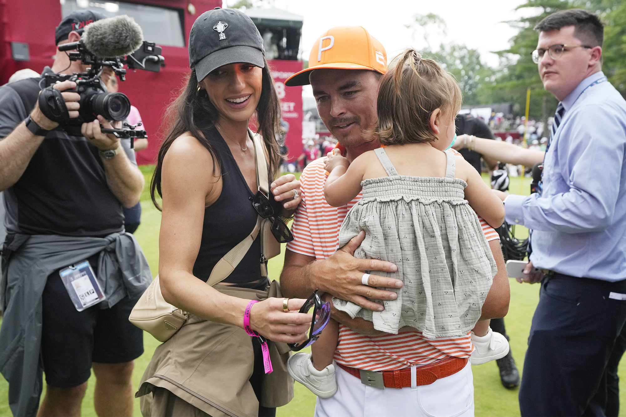 Rickie Fowler embraces wife Allison Stokke after Rocket Mortgage Classic