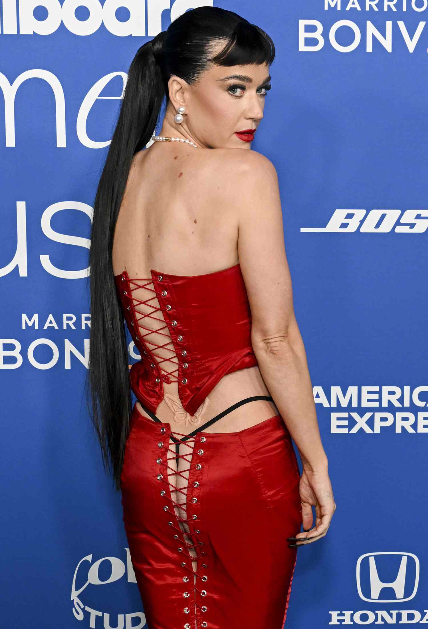 Katy Perry Flashes Her Thong and Backside in Red LaceUp Skirt