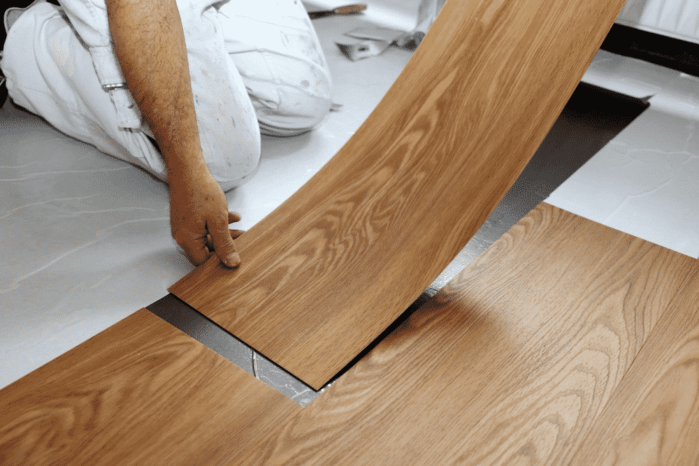Man laying PVC-floor Vinyl Flooring Pros and Cons