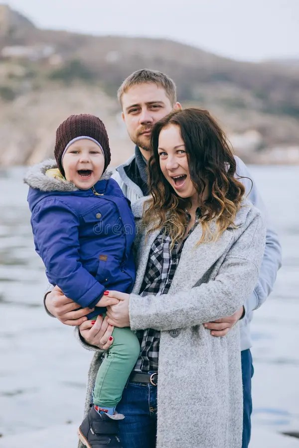 Happy Family mother, Father and Little Son Walking in Harbour Stock