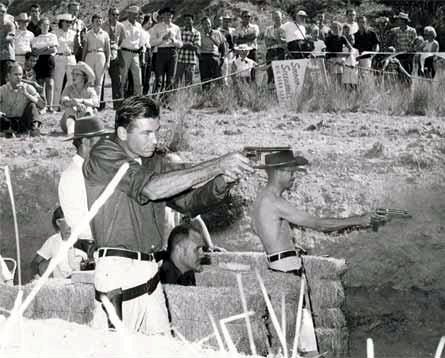Weaver vence en un Leatherslap en 1959. El que está agachado en medio de las pacas de paja es Jeff Cooper. Obsérvense las diferencias entre uno y otro tirador en cuanto a TTP