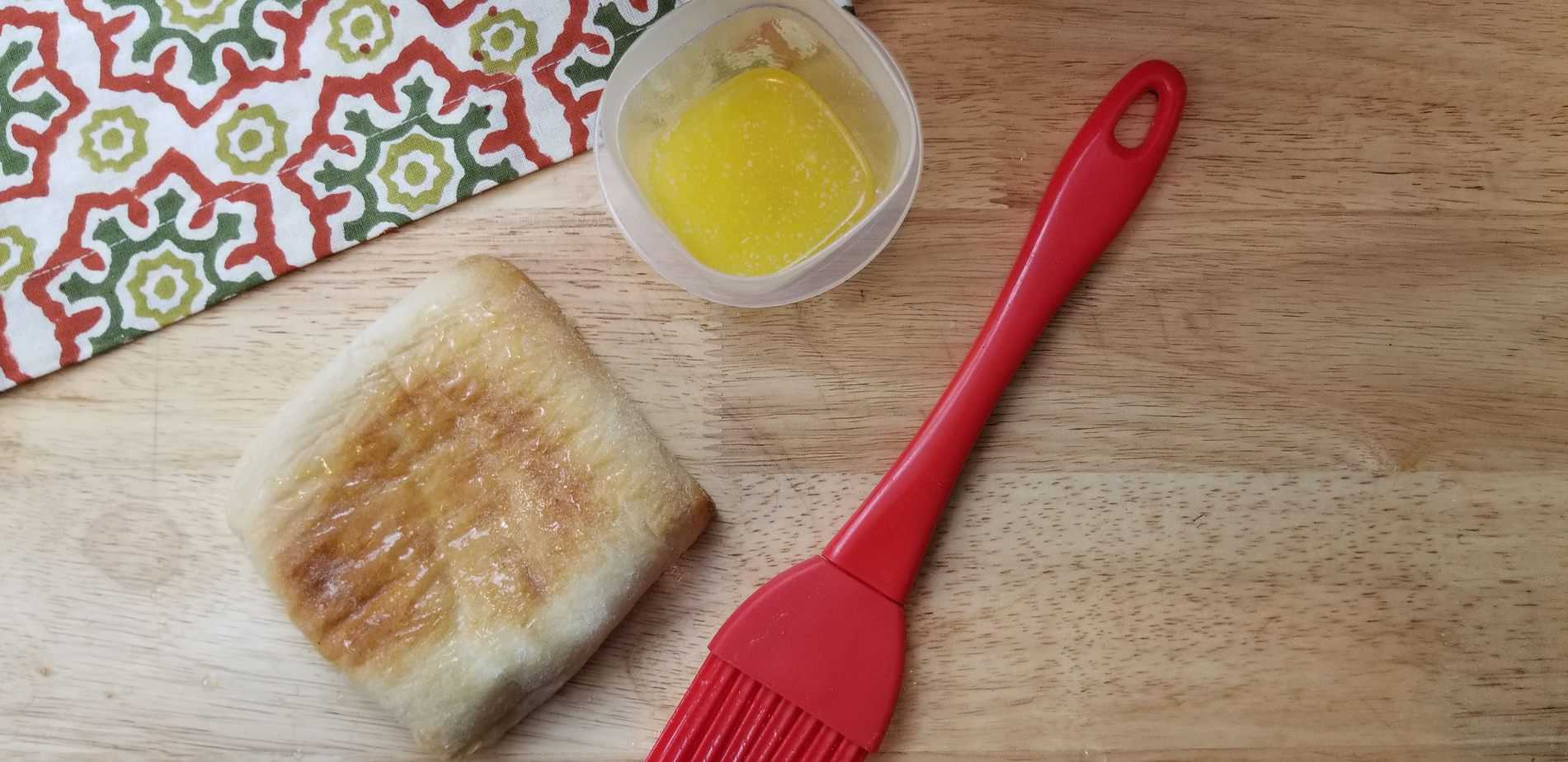 First step is to brush the back of the bread with melted butter
