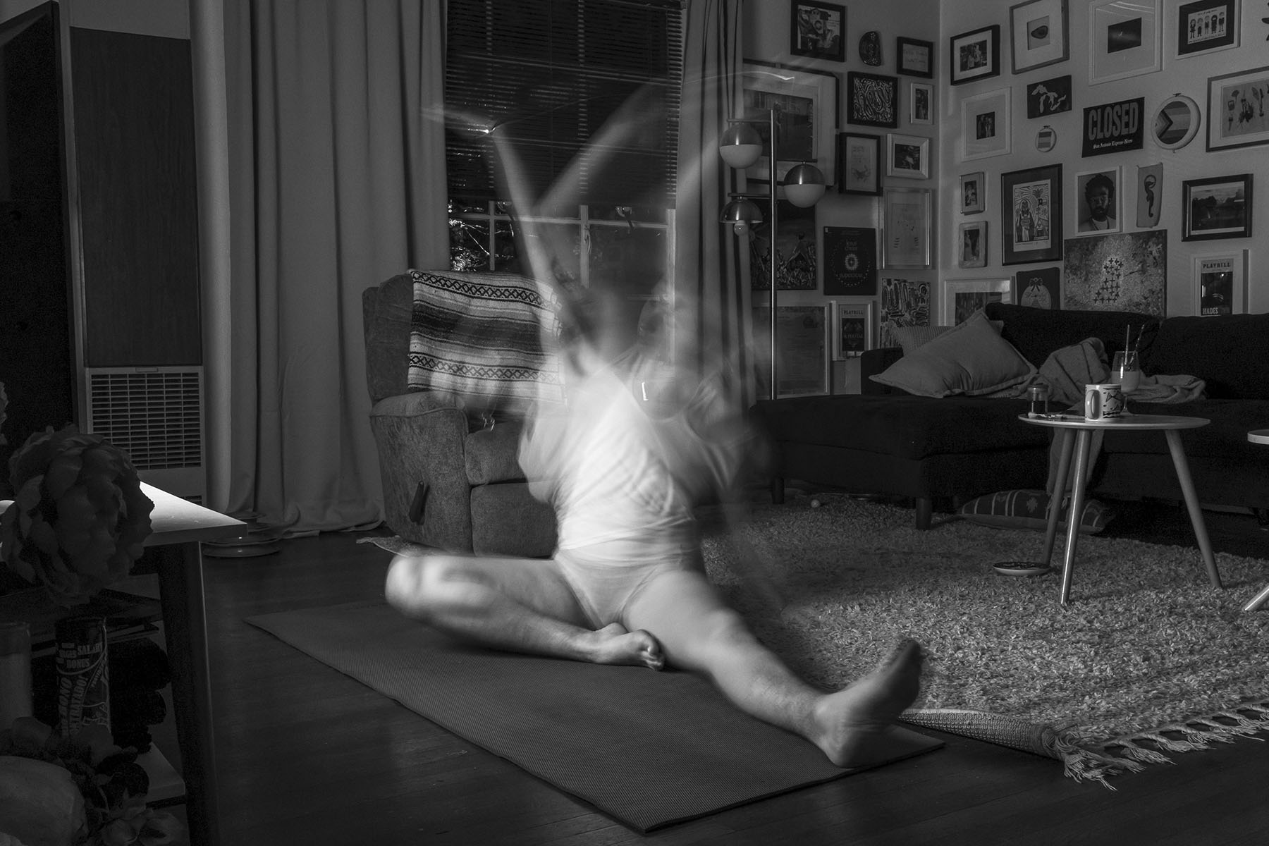 In a long exposure photograph, Josie Norris practice yoga in their living room at home on Sept. 26, 2022, in San Antonio, Texas. “After years of casually doing yoga, I started 2022 with over four months of a daily yoga practice. The benefits I felt were holistic and hard to sum up but my intuition started speaking up louder than it used to. But more importantly, I’ve been listening to what it says. When I step off the mat, I feel my body and mind reunited.”
