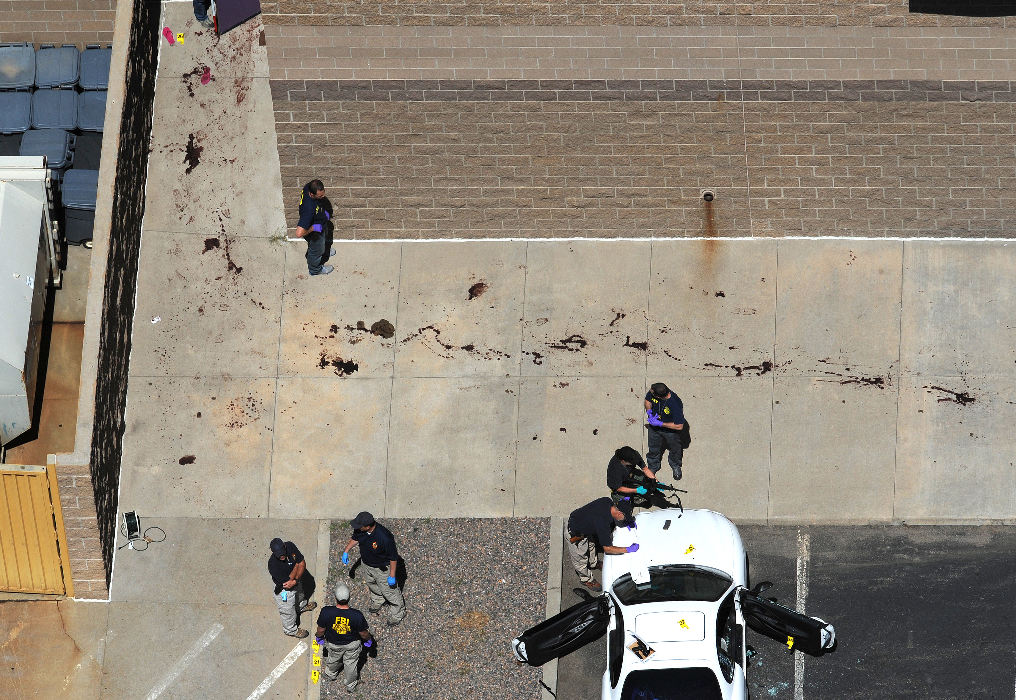ATF agents investigate the suspects car. ...