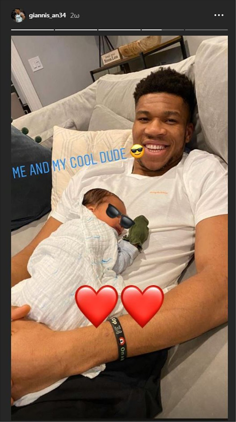 Giannis and Liam Charles Antetokounmpo poses with son on his lap