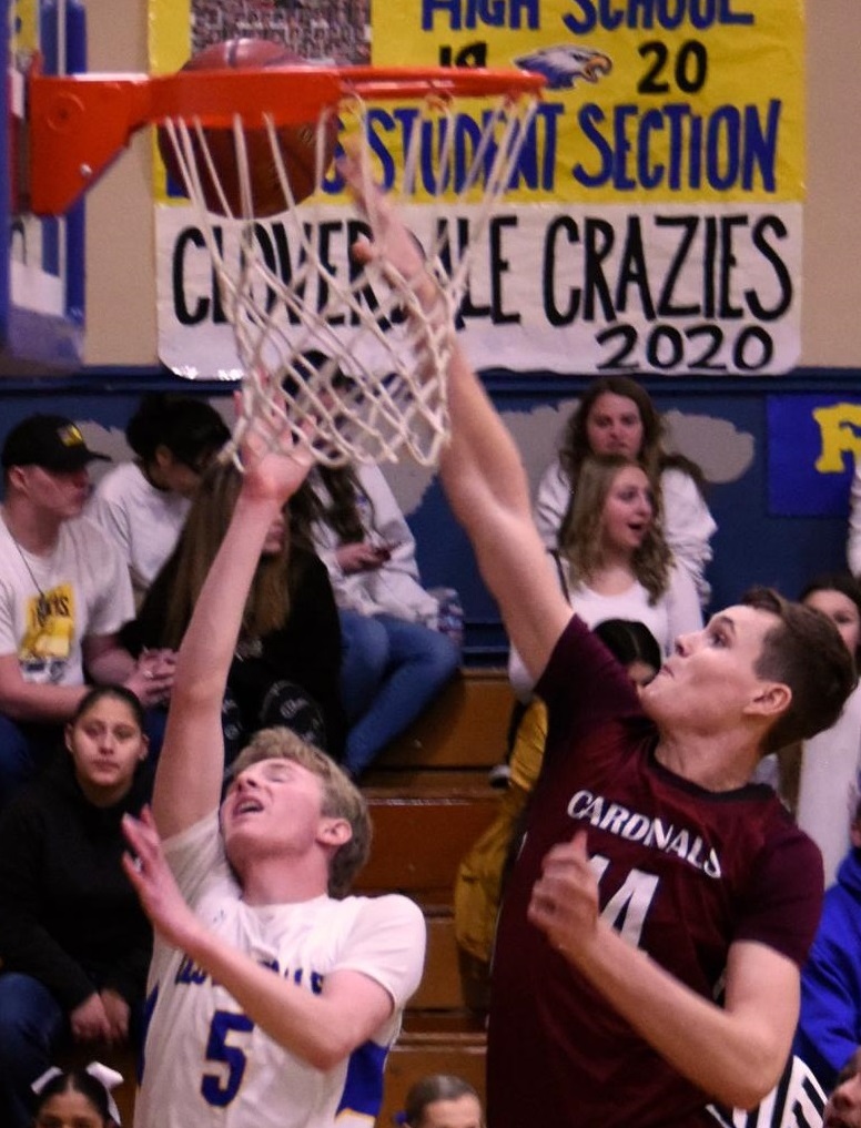 Clear Lake's Jaron Mertle tries for the block of Cloverdale's Spencer Hoover during a title-clinching 61-52 road victory nearly a year ago today, capping the Cardinals' perfect 14-0 league run. (Photo courtesy of Trett Bishop)