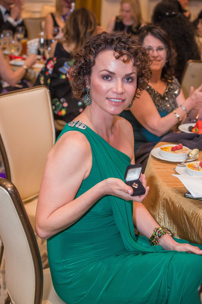 Heart Ball honoree Amy Tarkanian holding a Michael E Minden custommade