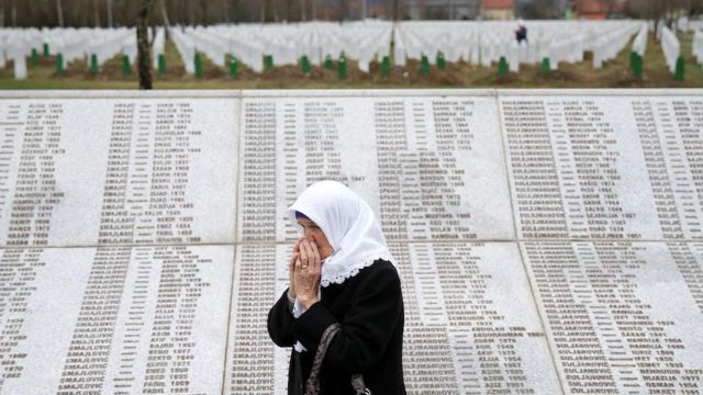 A woman is seen near a family grave at the Memorial centre Potocari near Srebrenica, Bosnia and Herzegovina on 20 March 2019
