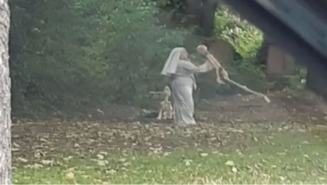 Photos of woman dressed as nun dancing with skeletons near English graveyard go viral