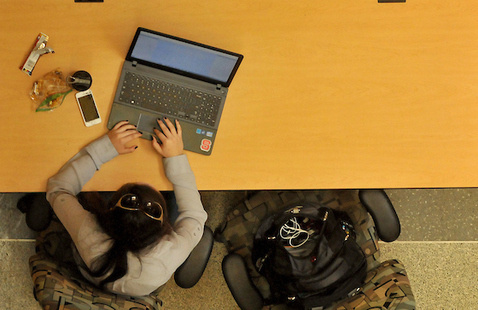 Student works on her laptop in EB1 on Centennial Campus.