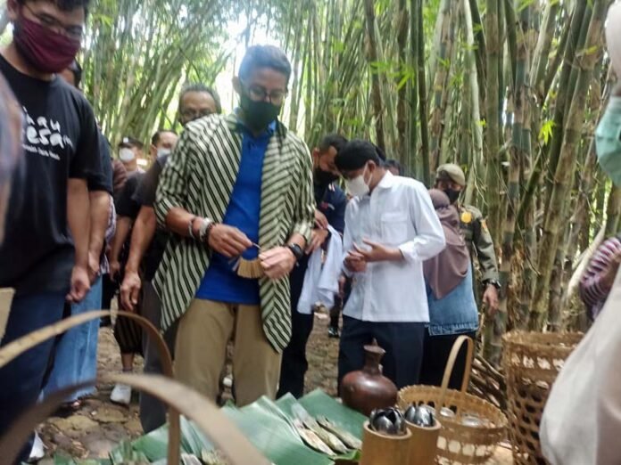 JAJAN. Menteri Pariwisata dan Ekonomi Kreatif Sandiaga Salahuddin Uno memborong jajanan di Pasar Papringan Desa Ngadiprono Kedu, Minggu (13/3).(foto:setyo wuwuh/temanggung ekspres)