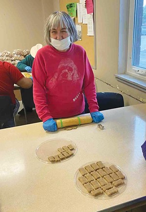 Donna proudly displaying the biscuits she has cut out. Sparc’s dog biscuits are available at Hy-Vee and participating retailers in the Springfield area. - PHOTO COURTESY SPARC