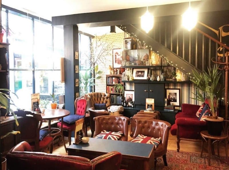cafe with cosy club chairs and bookcases