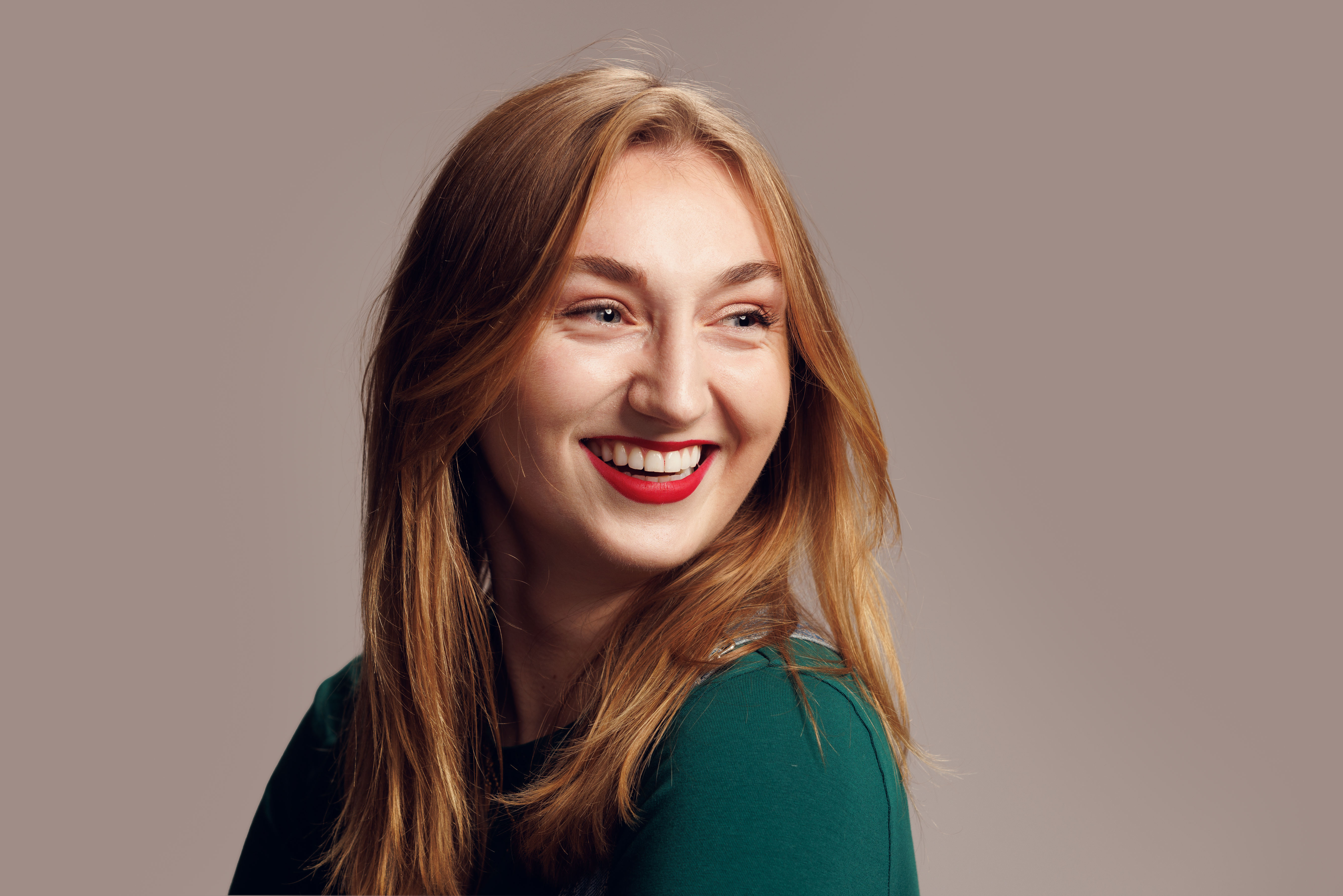 Image of a female student looking over her shoulder and smiling