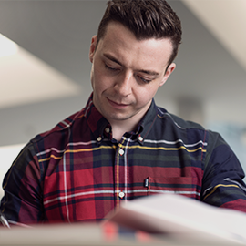 male student reading a book