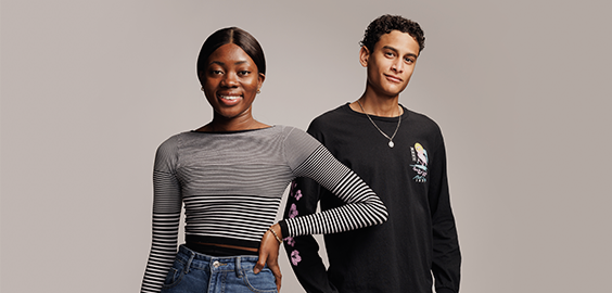 two students - one male, one female - smiling at the camera