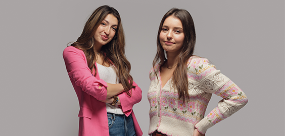 two female students smiling at the camera