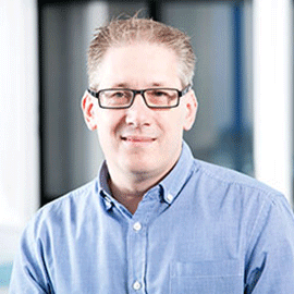 a man wearing glasses and a blue shirt