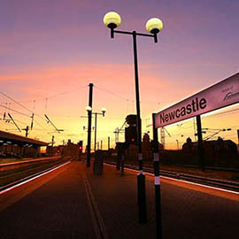 a sunset over a city street