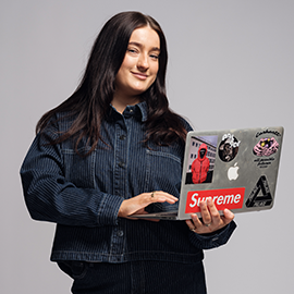 student holding laptop