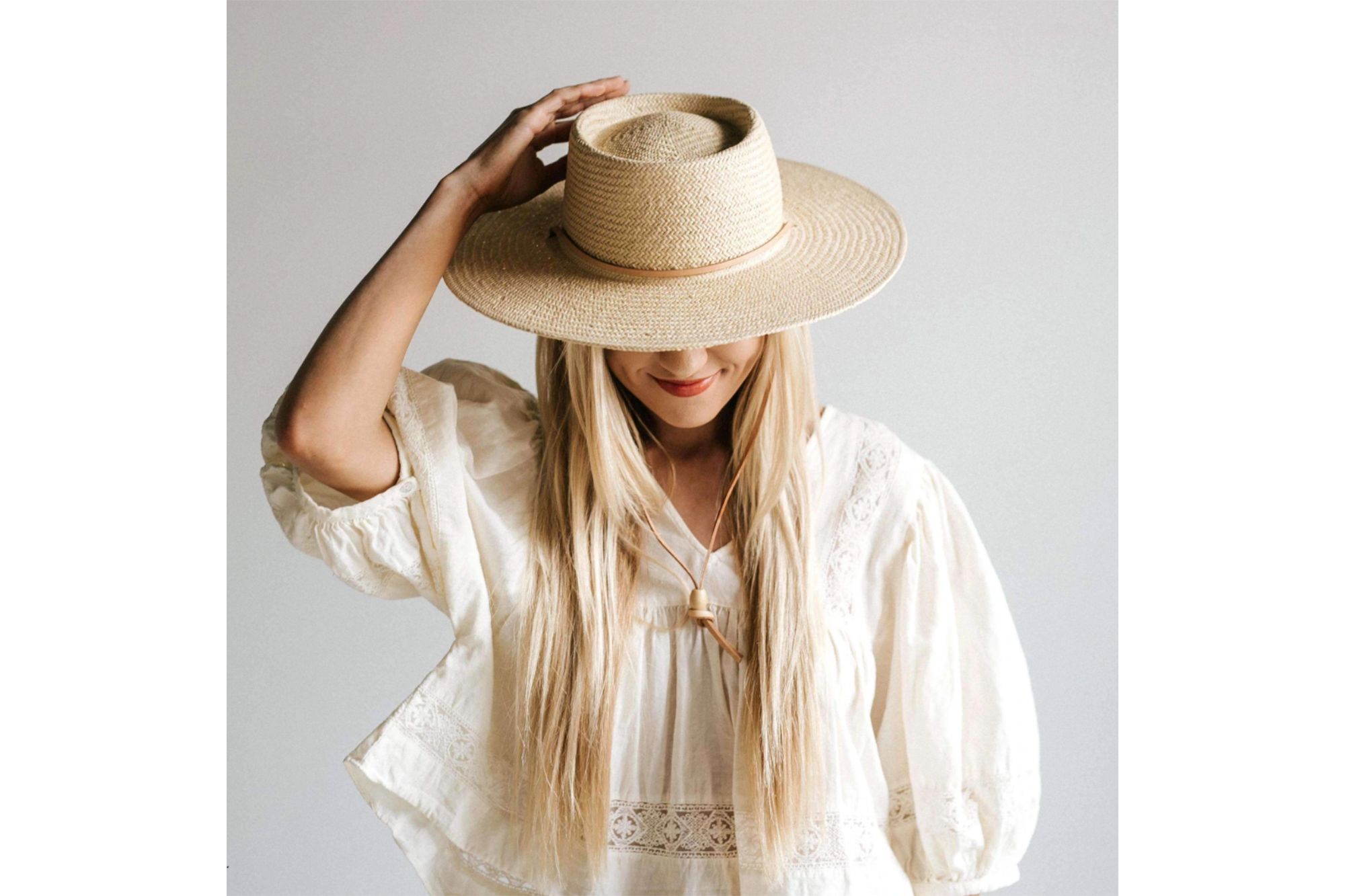Woman wearing straw wide brim hat