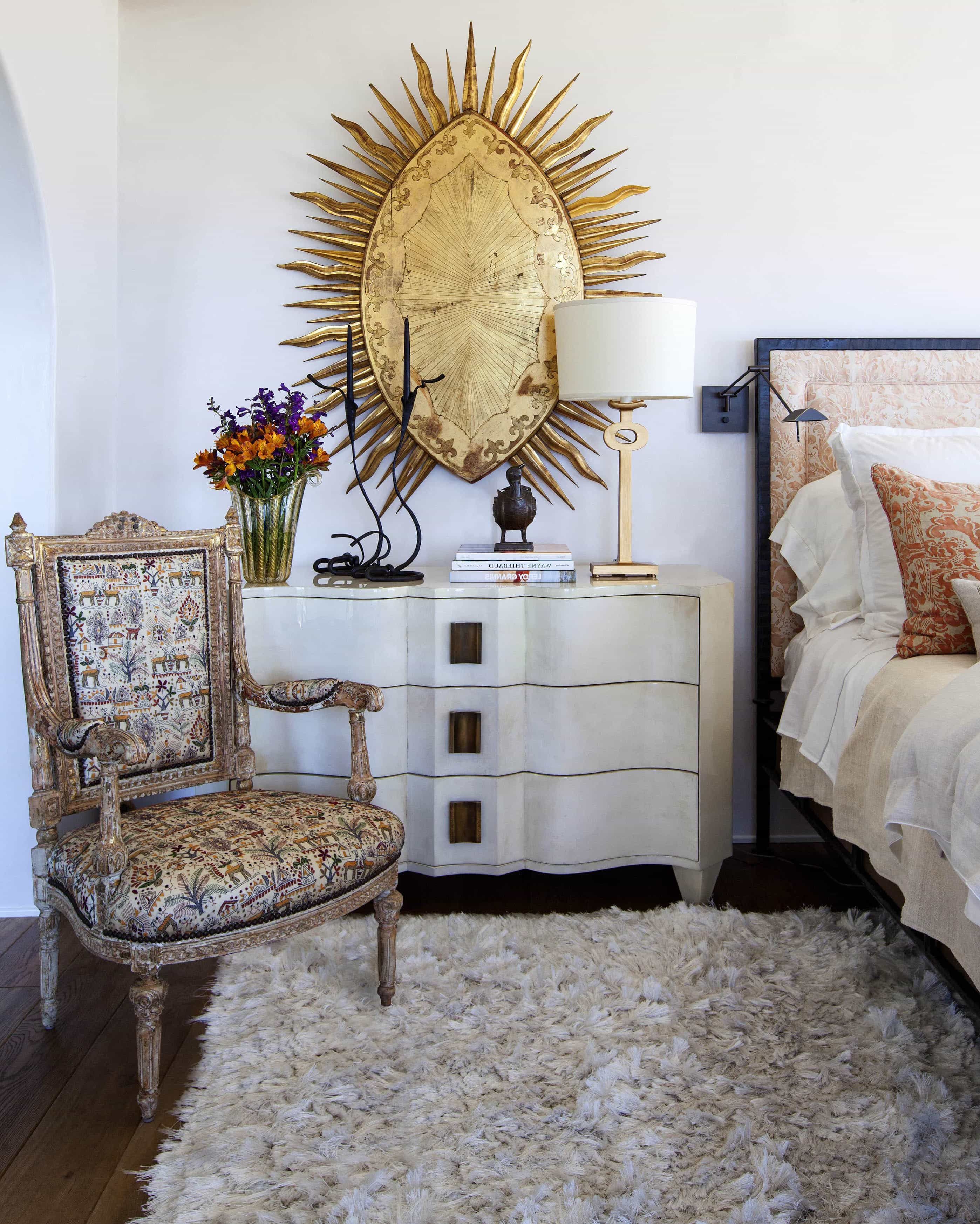 White Bedside Table With Large Metal Hanging Art With Flokati Rug And Upholstered Chair (Photo 1 of 10)