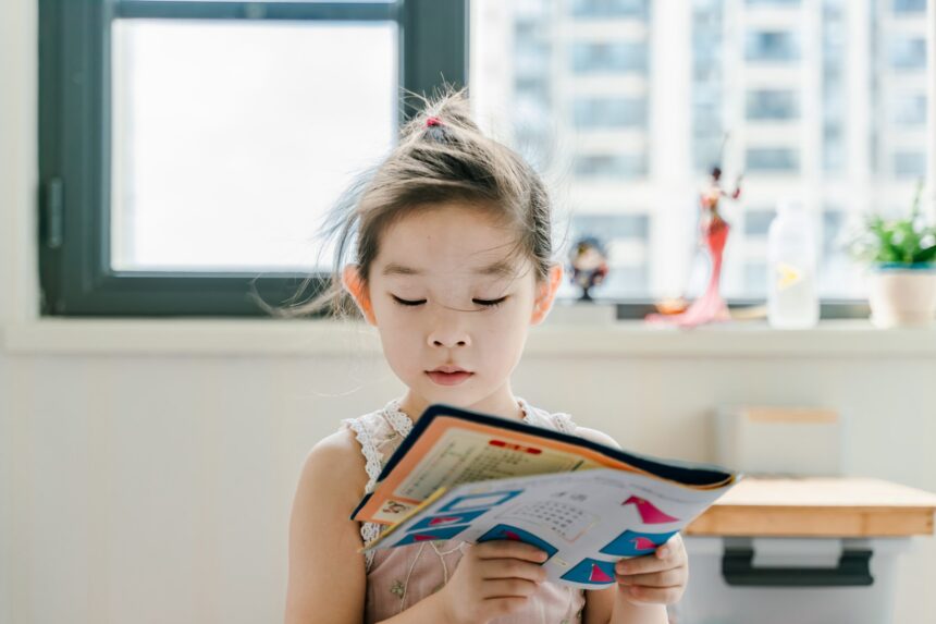 child reading a book as part of an activity during a mental health day