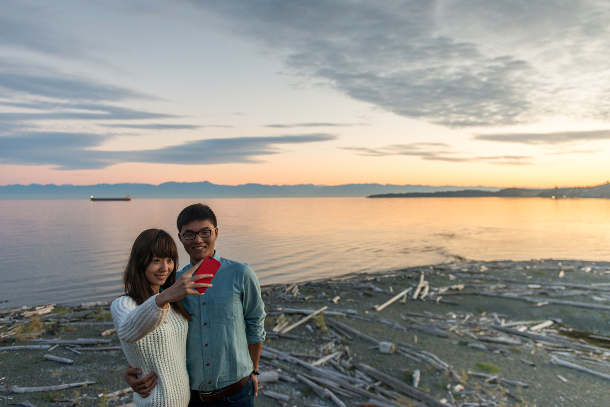 Two people taking a selfie on a beach