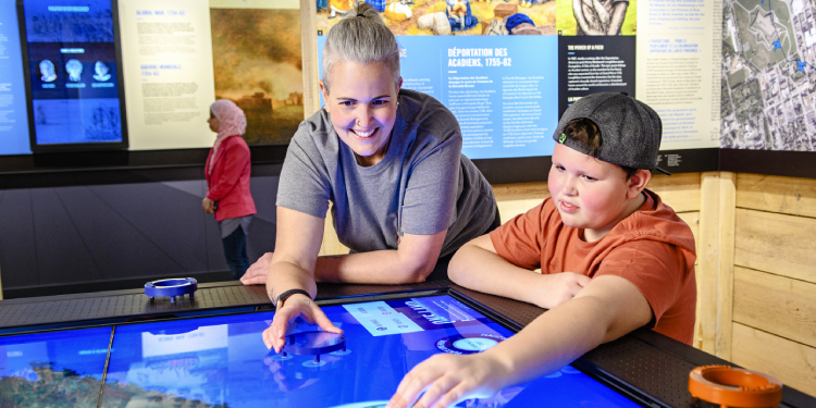 Visitors use the digital interactive One Land, Four Peoples of the exhibit Fortress Halifax: A City Shaped by Conflict at the Halifax Citadel National Historic Site, 2021