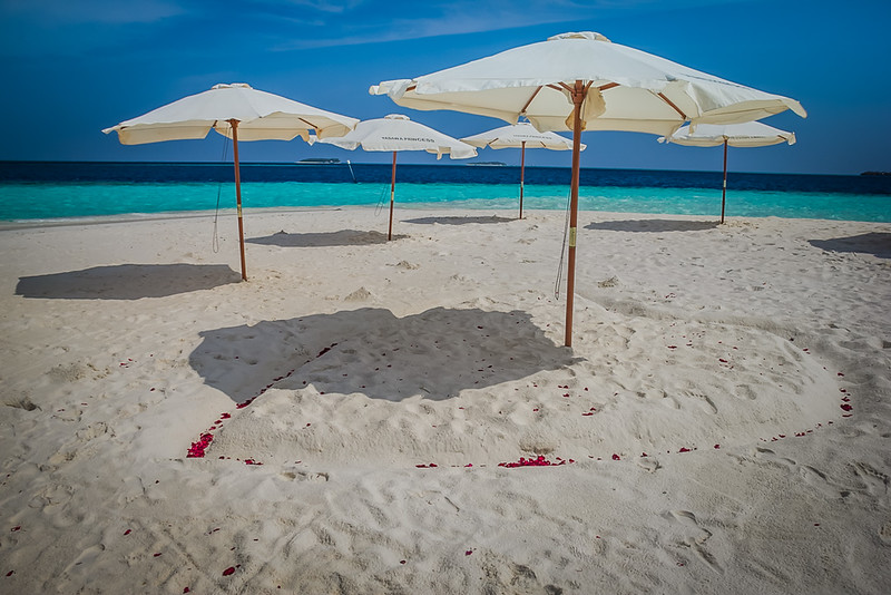 Umbrellas on a beach in the Maldives - beach packing list