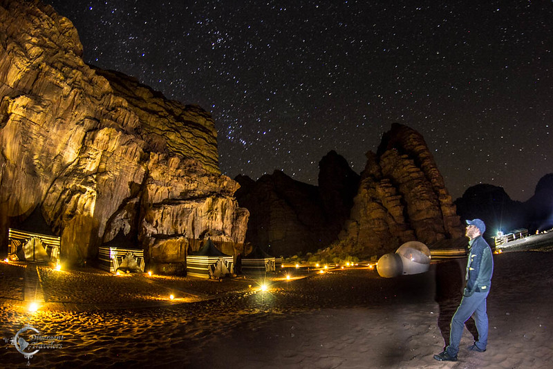 David Stock Jr of Divergent Travelers Adventure Travel Blog looking up at the night sky in Wadi Rum