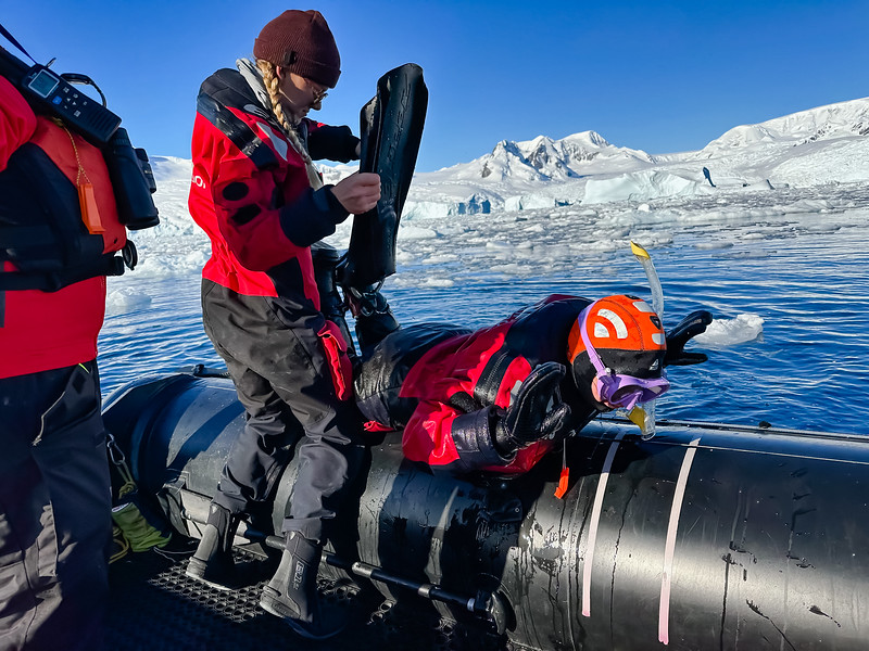 Lina Stock getting back into a zodiac in Antarctica after snorkeling