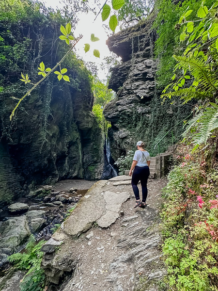 Lina Stock with a waterfall while hiking to Landshut Castle from Bernkastel, Germany in the Moselle Valley