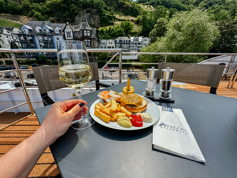 BBQ plate with glass of wine on the top deck of the Imagery II with Avalon Waterways on the Moselle River
