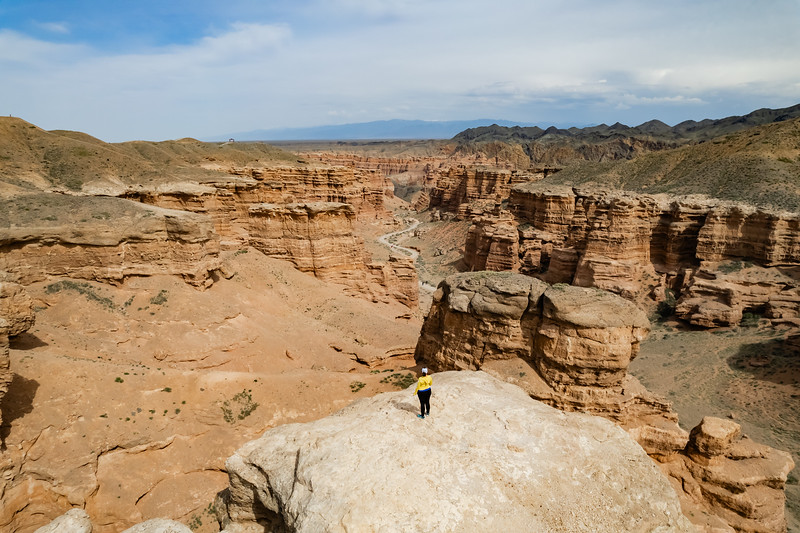 Lina Stock standing on a rock overlooking Charyn Canyon in Kazakhstan